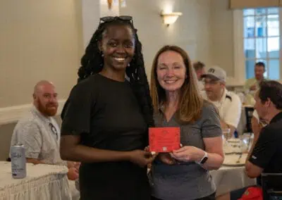 Photo from Whitby Golf tournament, two women posing with card.