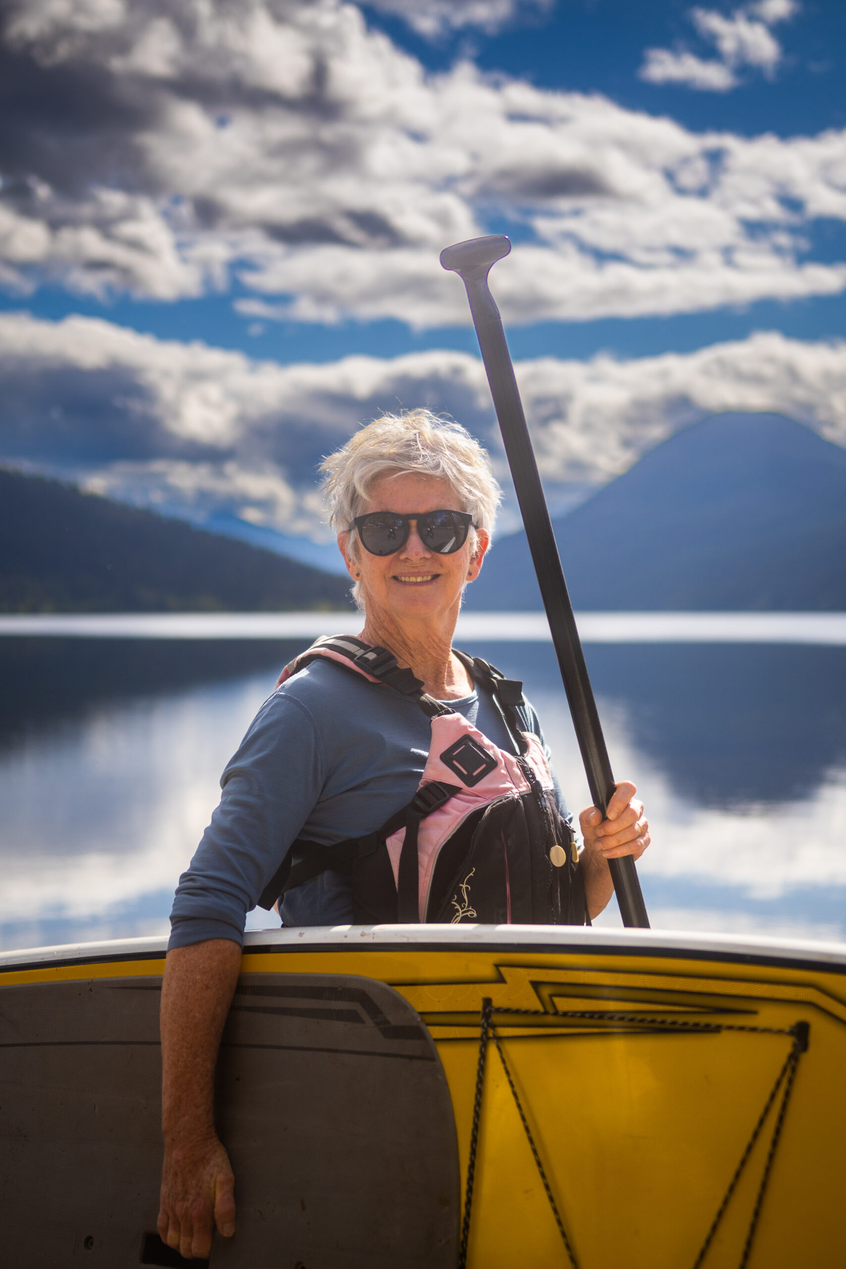 person at lake with paddle board